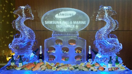 Snowfilled Logo on top of shushi tower with japanese fish luge on each end of 80 inch tray