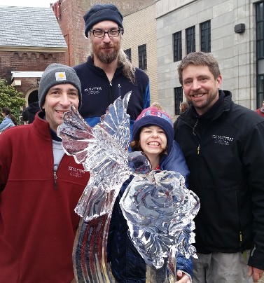 Our biggest fan, Georgia, with Gary, JP and Bill, standing with the sculpture Bill made of her favorite animal - a hummingbird