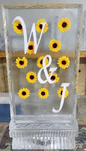 ice matters silk flowers frozen into block with snowfilled initials vertical